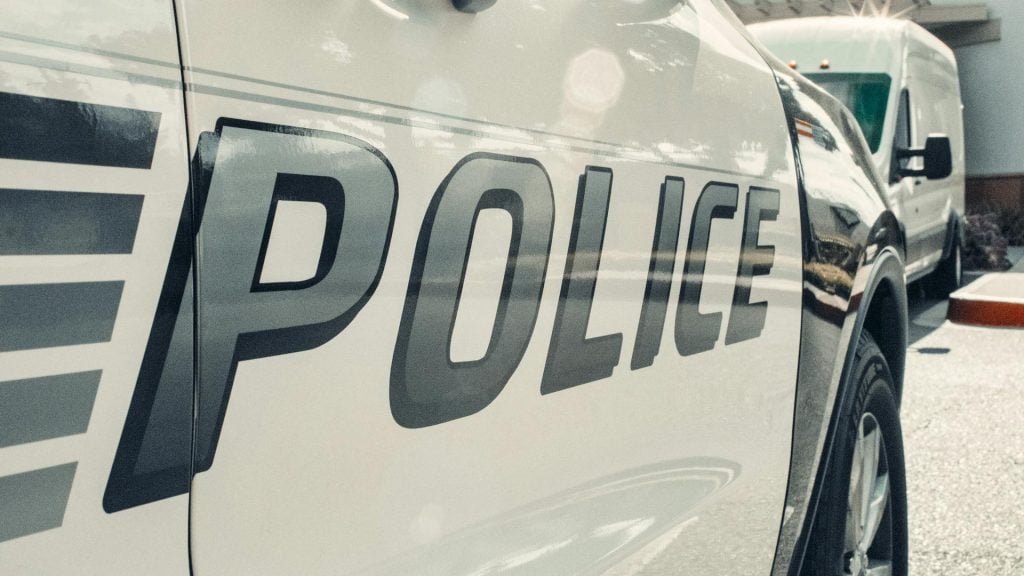 view of a police car from the side with the word "Police" visible